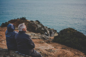 elderly people looking out over the water