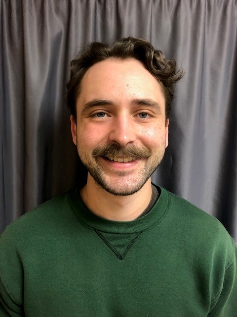 Tyson, an RN, standing in CHCC smiling.