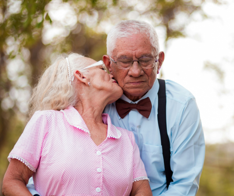 a couple in love, giving each other a kiss. When caregiving at home becomes too much.